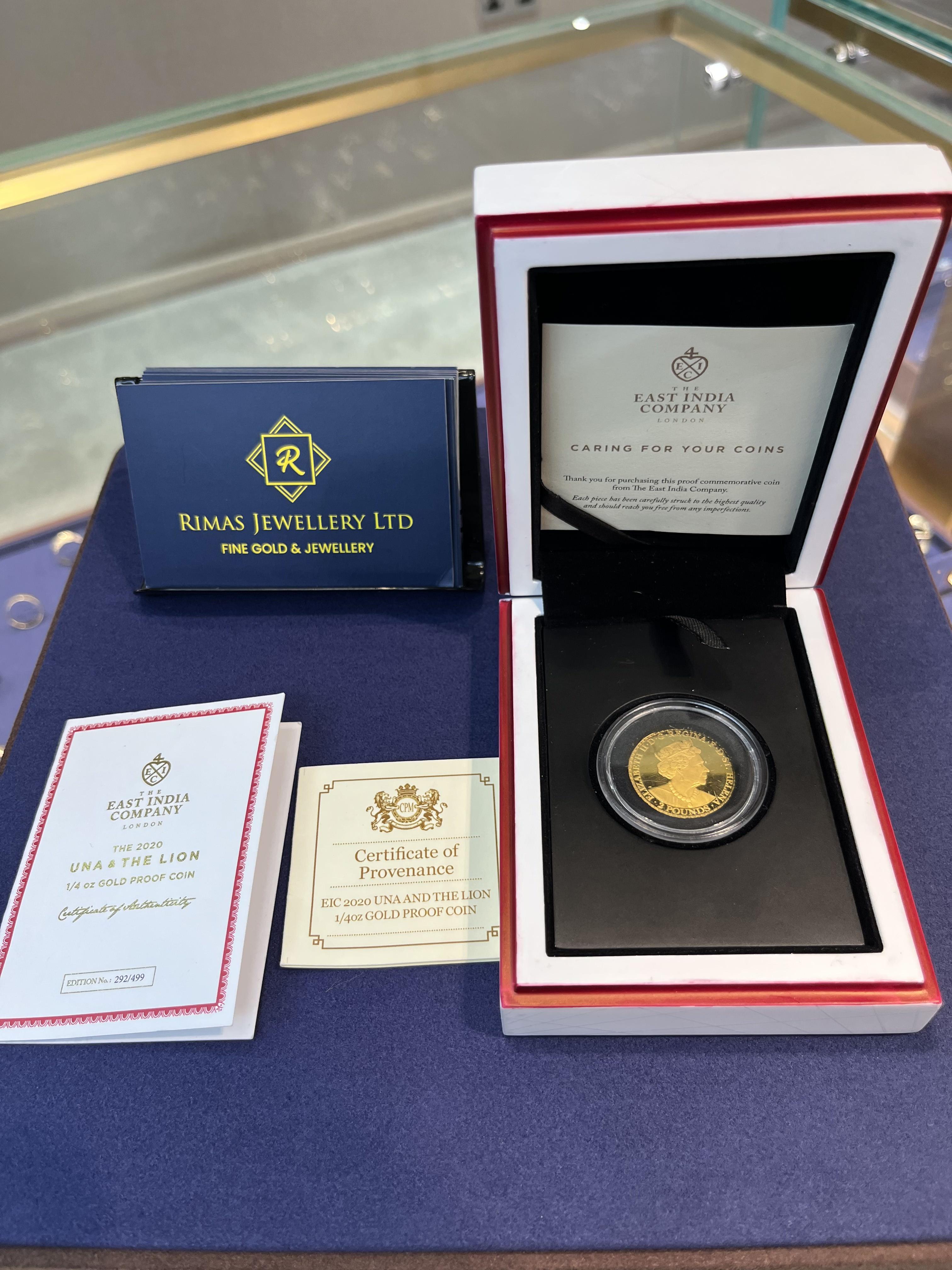 A cased quarter-ounce gold proof coin with its certificates, beside a Rimas Jewellery card.